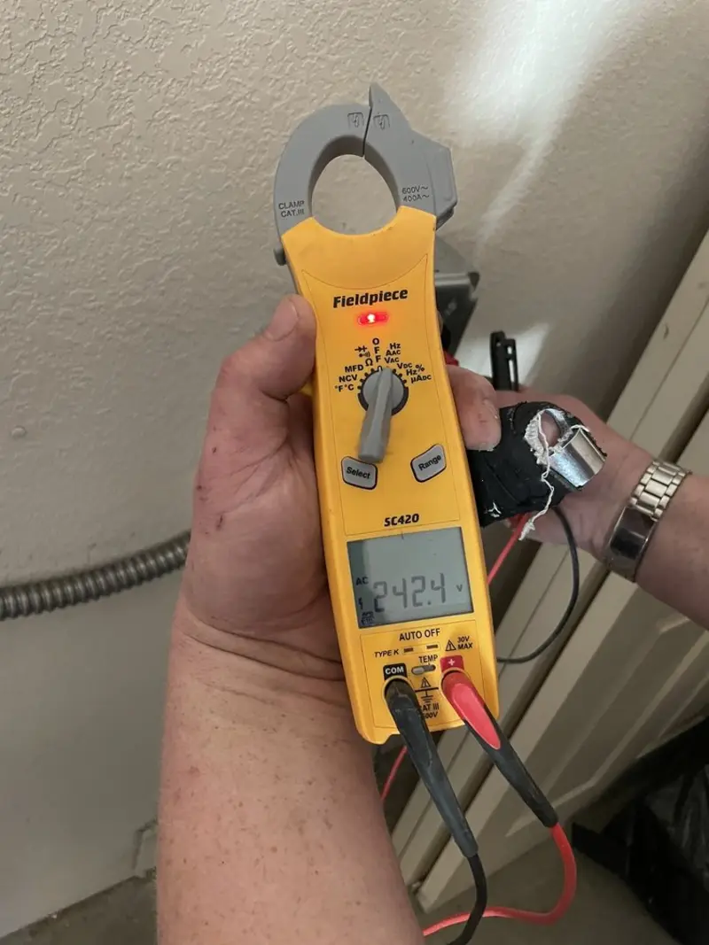 Voltage testing with clamp meter during Recessed Lighting Installation in Groves